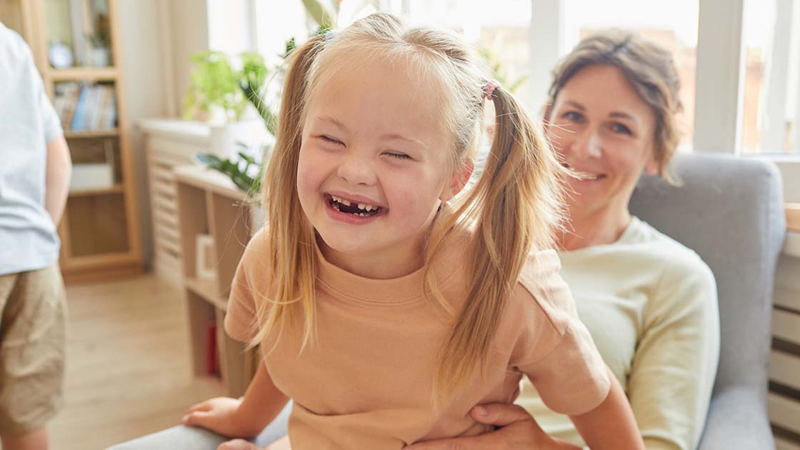 Girl laughing with mom